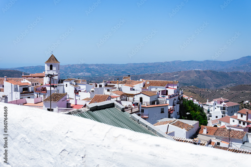 Small and white village with a church in the middle