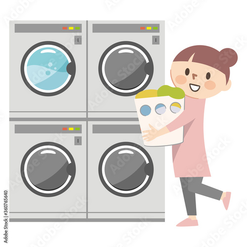 コインランドリーで洗濯をする若い女性