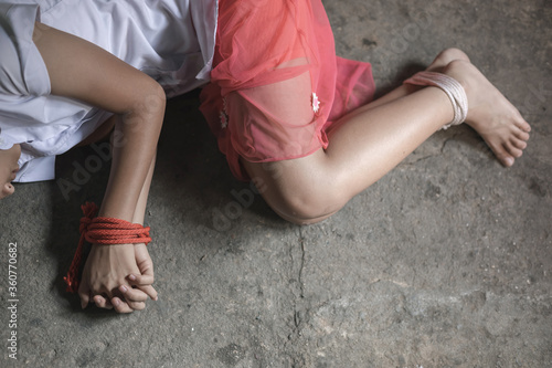 A victim tied up with rope. Stop violence against Women. International women's Day. Stop abusing violence.