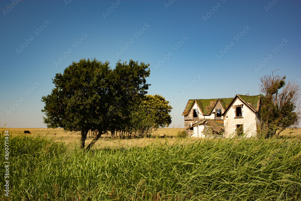 Dilapidated Abandoned Farm House in an Open Field in USA Dilapidated Abandoned Farm House in an Open Field in USA