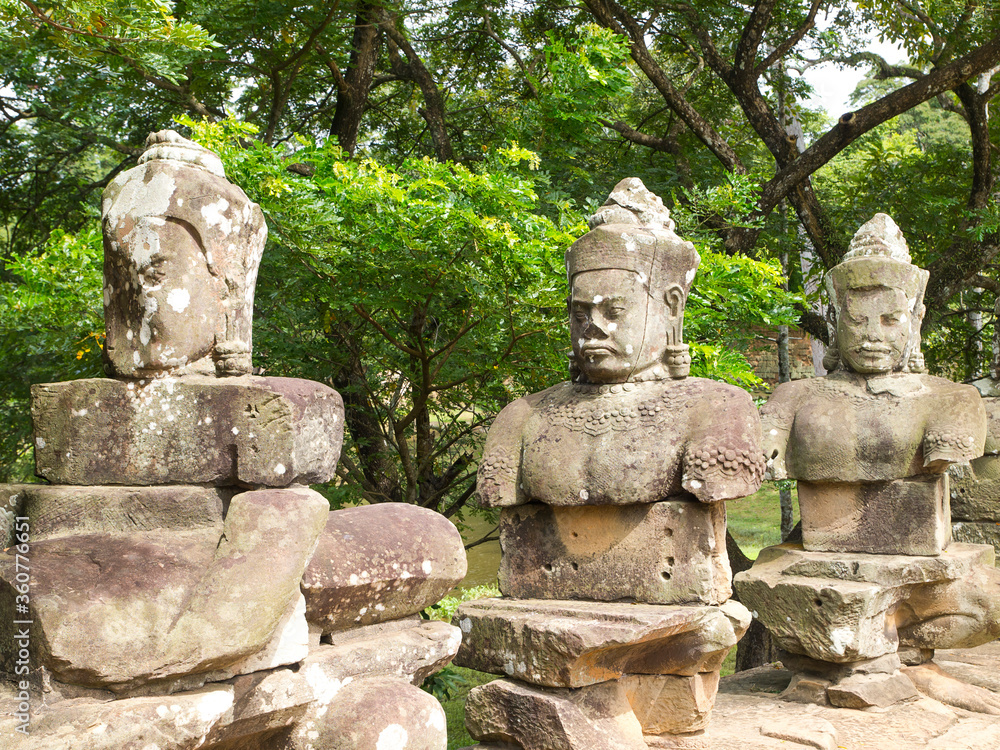 The ancient stone statue of Khmer god on the south gate of Angkor Thom, the world heritage site in Siem Reap province, Cambodia The ancient stone statue of Khmer god on the south gate of Angkor Thom, the world heritage site in Siem Reap province, Cambodia