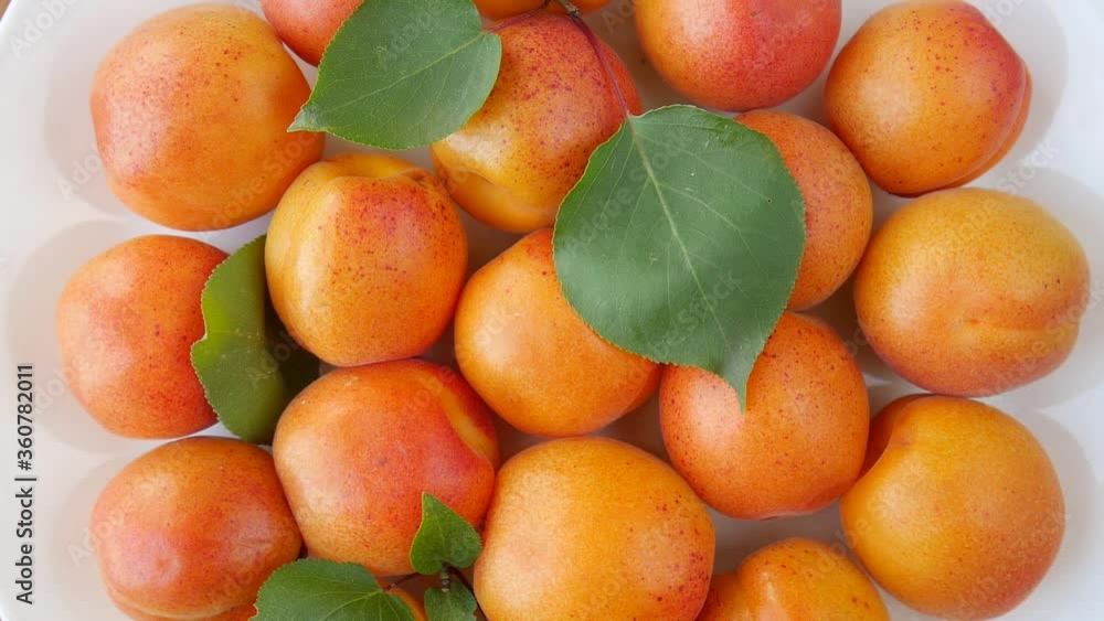Ripe apricots on a plate.