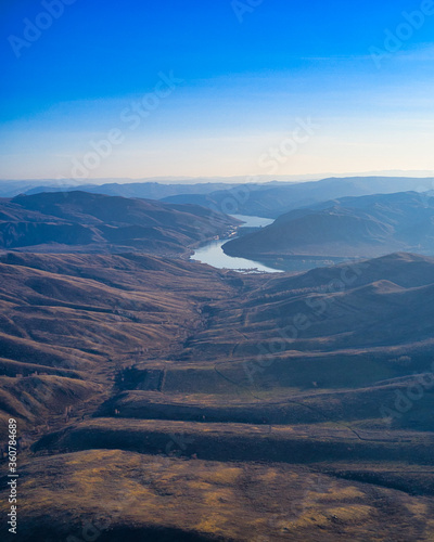 Blue sky. Mountain panorama. River valley between mountains.