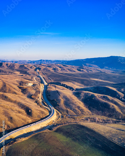 The road between the hills. Blue sky. Mountain landscape.