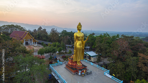 .aerial view sunset at Wat Phra That Jom Wae or Black Scorpion Temple on the high mountain in Chaing Rai Thailand