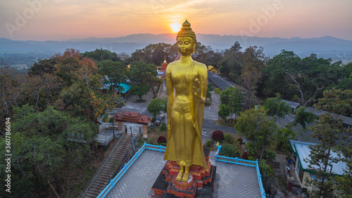 .aerial view sunset at Wat Phra That Jom Wae or Black Scorpion Temple on the high mountain in Chaing Rai Thailand