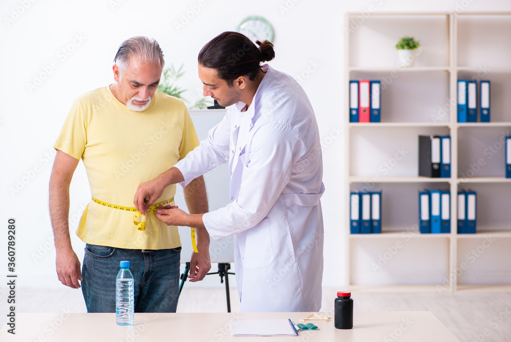 Fototapeta premium Doctor dietician giving advices to fat overweight patient