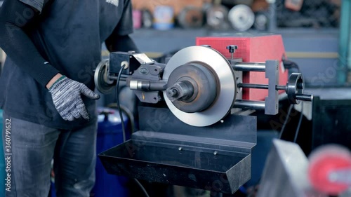 close up of a person working on a machine