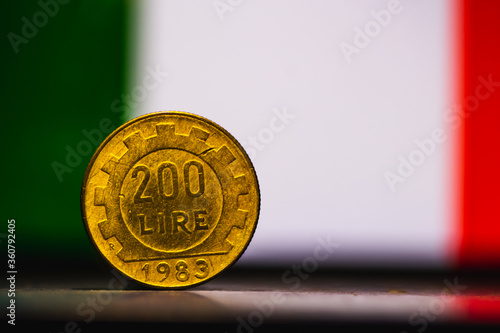 Italian 200 lire coin.Front side of two hundred Italian lire isolated on Italy flag, 1983. Vintage coin with space for text copy. repvbblica italiana 200. photo