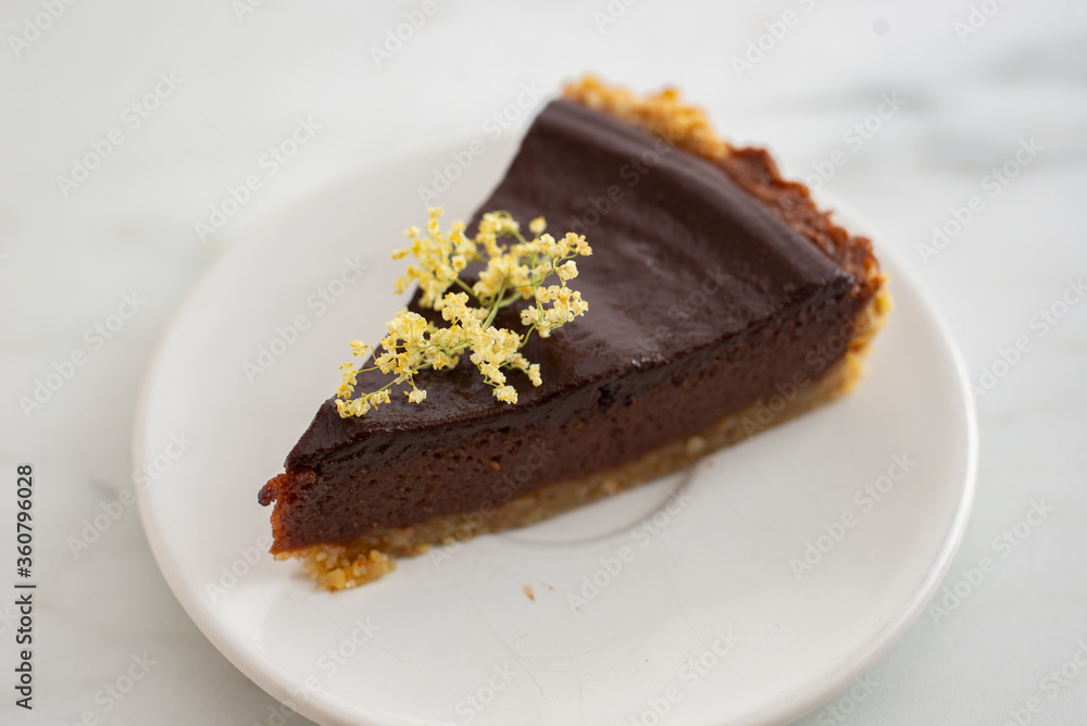 sweet home made chocolate elderflower cake on a table sweet home made chocolate elderflower cake on a table