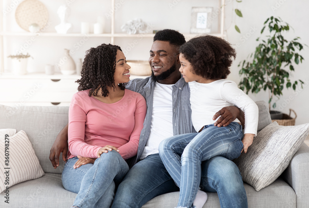 Portrait of happy black family resting together on couch at home Portrait of happy black family resting together on couch at home