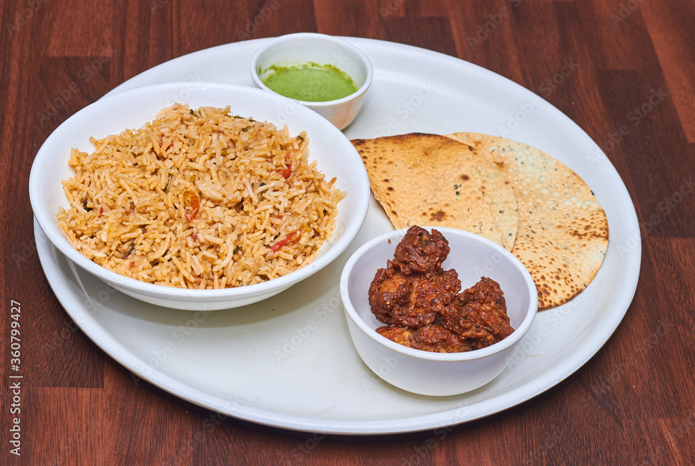 Chicken Biryani is a savory chicken and rice dish that includes layers of chicken, rice, and aromatics that are steamed together. Chicken Biryani is a savory chicken and rice dish that includes layers of chicken, rice, and aromatics that are steamed together.