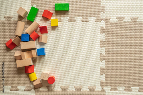 wooden building blocks on interlocking floor mat