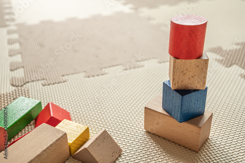 wooden building blocks on interlocking floor mat