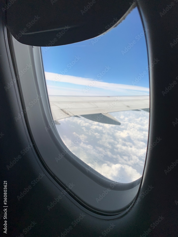 A view through an airliner window, of the wing, while flying.