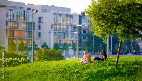 Couple relaxing on the grass in the city 