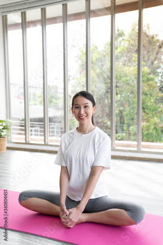 Portrait young asian woman hold yoga mat after finished class with copy space