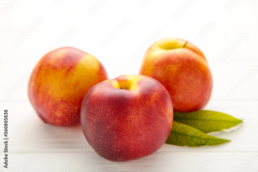Many fresh nectarines on white wooden background. Many fresh nectarines on white wooden background.