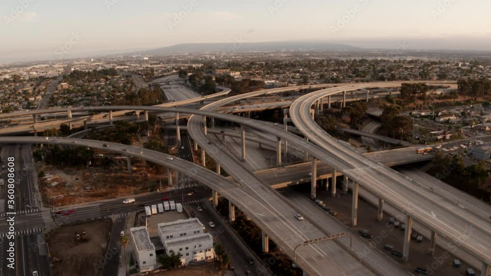 Aerial of freeways in Los Angeles, highway junction, top perspective, urban view, sunset in big city Aerial of freeways in Los Angeles, highway junction, top perspective, urban view, sunset in big city