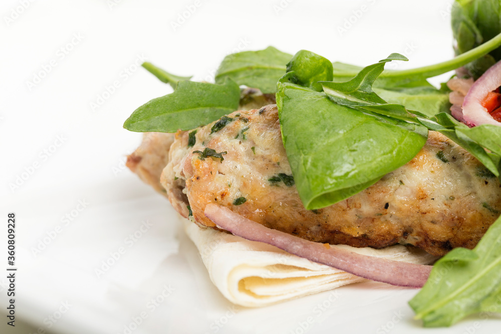 Fragment of dish chicken kebab and a salad.