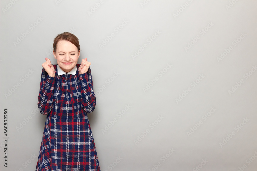 Portrait of happy overjoyed girl raising fists up in triumph Portrait of happy overjoyed girl raising fists up in triumph