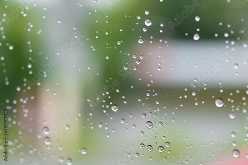 A window glass with raindrops due to rain. A rainy day. © Macky Albor