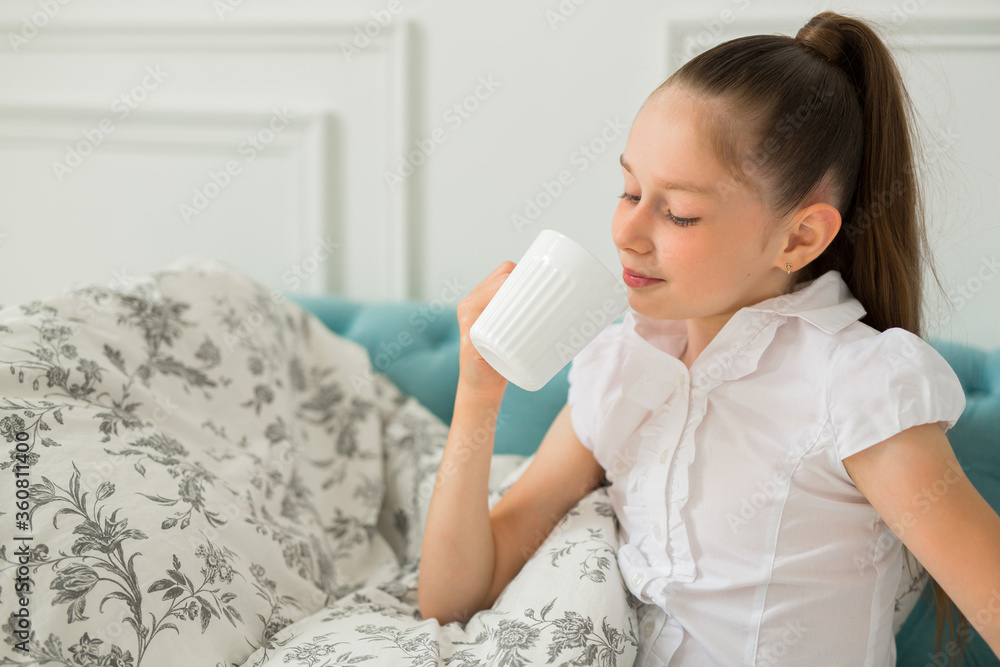 beautiful young teenager girl in a blanket with a mug beautiful young teenager girl in a blanket with a mug