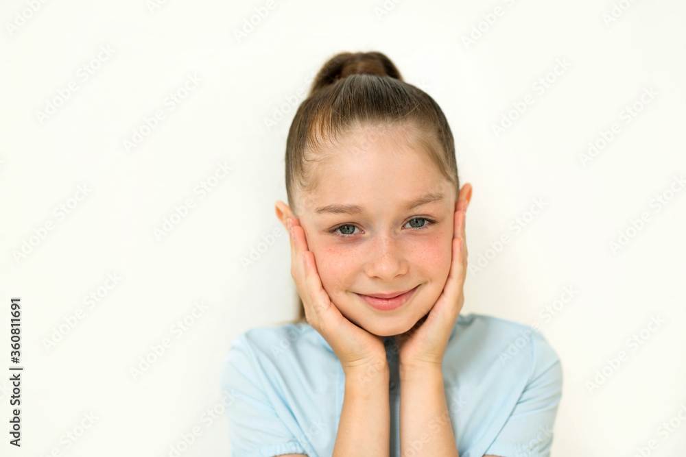 beautiful young teen girl on a background of a white wall beautiful young teen girl on a background of a white wall