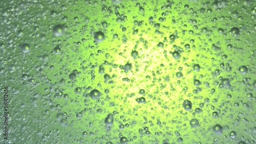 air bubbles float in liquid with colour light.