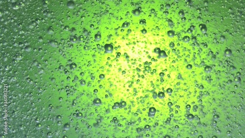 air bubbles float in liquid with colour light.