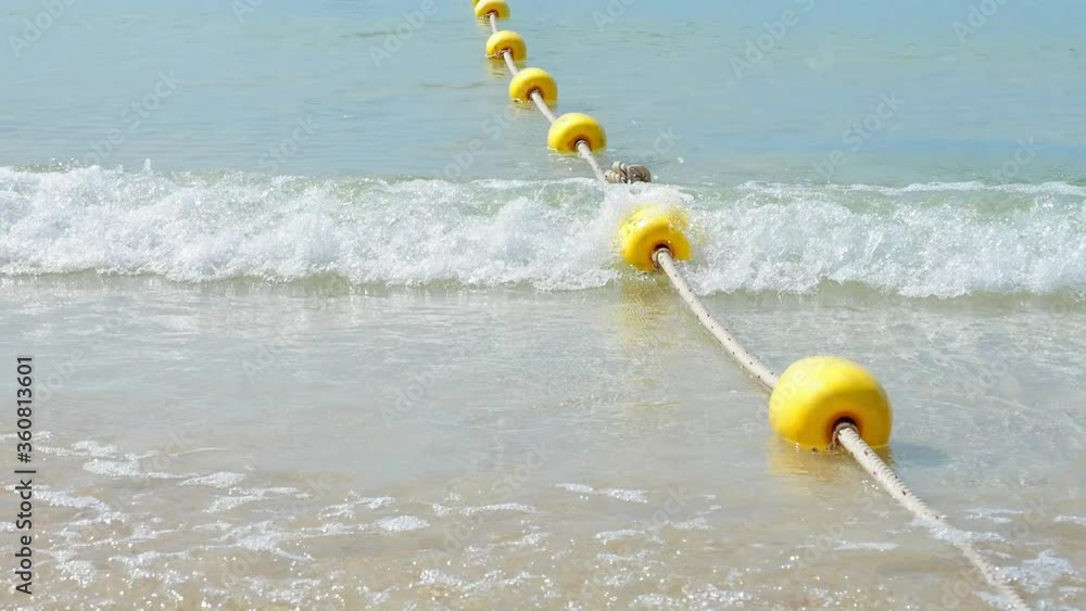 Vidéo Stock Yellow buoy is a channel buoy in the sea with rope boundary ...