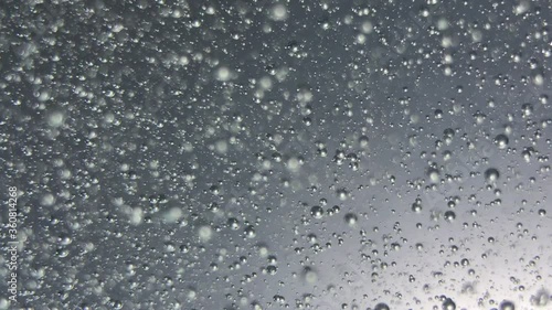 air bubbles float in liquid with colour light.