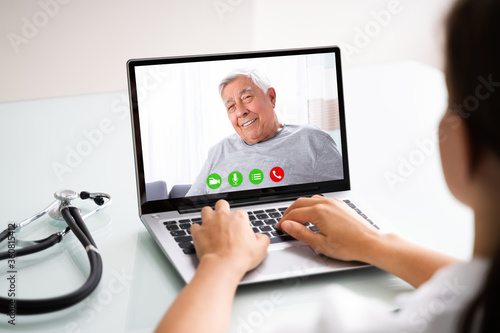 Doctor Talking To Male Patient Through Video Chat