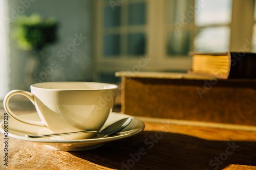 Fototapeta Naklejka Na Ścianę i Meble -  A white coffee mug on a wooden office desk