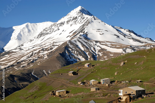 Kurush village (the southernmost point of Russia and the highest mountain settlement in Europe, 2560 m) and Mount Bazarduzu (4,467 m, the highest peak in Azerbaijan). Dagestan, North Caucasus, Russia. photo