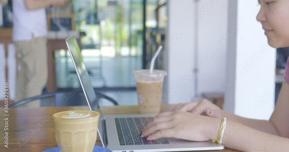 Business asian women typing laptop drinking hot coffee Business asian women typing laptop drinking hot coffee