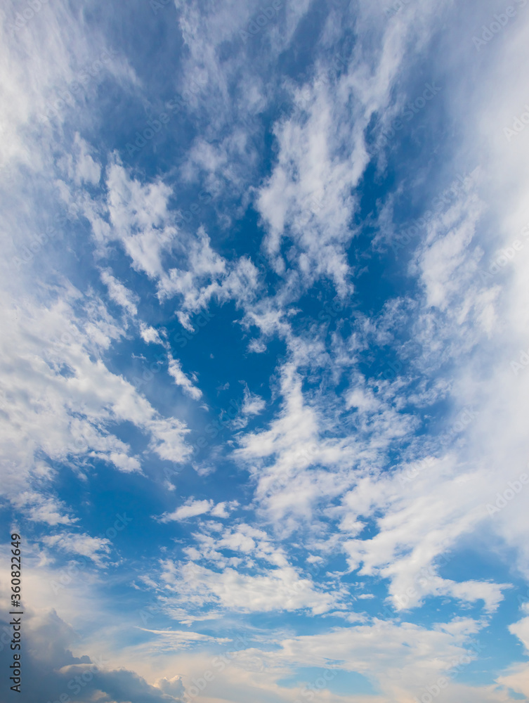 Vertical panorama of blue sky with white clouds
