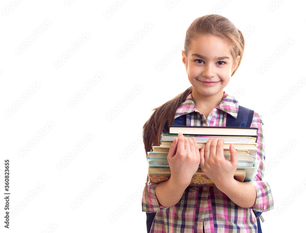 Little smiling schoolgirl with books in hands looking in camera Little smiling schoolgirl with books in hands looking in camera