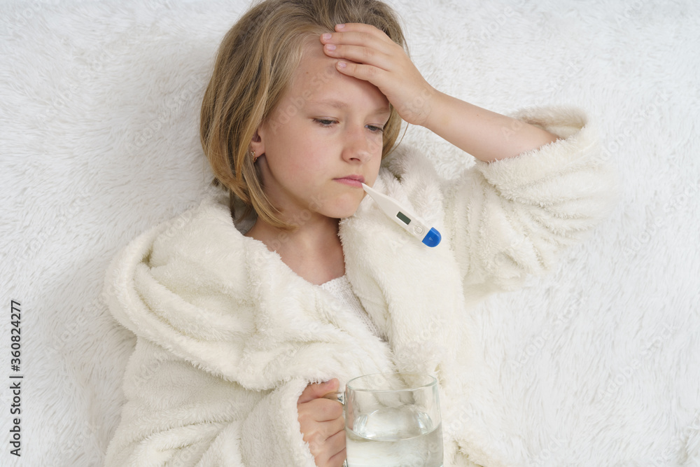 A sick teenage girl clings to her head. A sick teenage girl clings to her head.