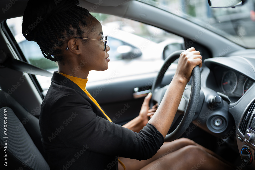 African Woman Holding Steering Wheel