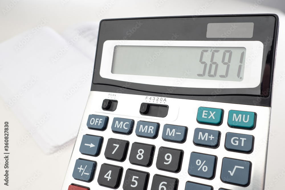 Calculator close-up. Counting money with a calculator. Calculator on the background of empty documents. Analysis of the budget of the company. Counting personal finances. Calculation of Tax Payments Calculator close-up. Counting money with a calculator. Calculator on the background of empty documents. Analysis of the budget of the company. Counting personal finances. Calculation of Tax Payments