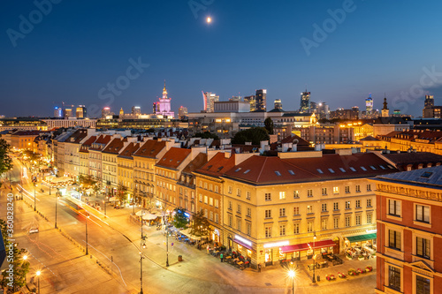 Old town with modern skyscrapers at background at night in Warsaw, Poland