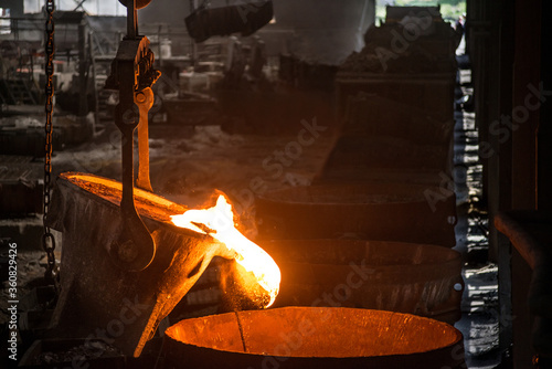 Tank pours liquid metal at the steel mill photo