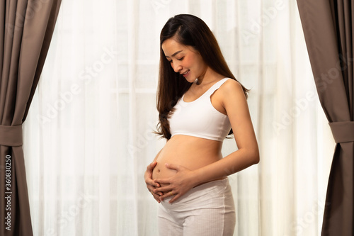 Asian teen beautiful in Pregnancy 20 week posing relex smile in bedroom her by touch cute pregnant belly beside windows Free Download Asian teen beautiful in Pregnancy 20 week posing relex smile in bedroom her by touch cute pregnant belly beside windows - GFXLoad