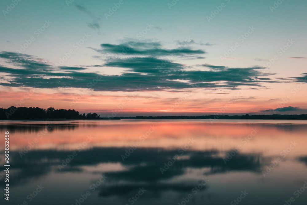 beautiful sunset over the lake. bloody sunset over a calm lake