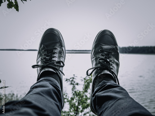 leather shoes and a lake in the background © Alexander