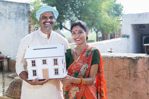 Photography Indian rural Couple holding model house at village