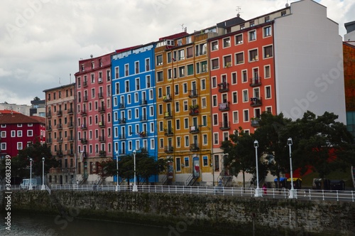 buildings of different colors next to rio Nervion in Bilbao, Spain photo