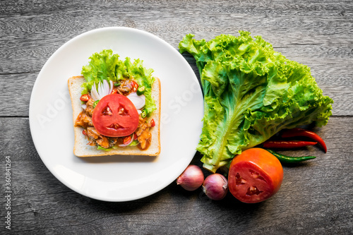 Food art and creativity from canned fish and bread. Fast food on wooden background.