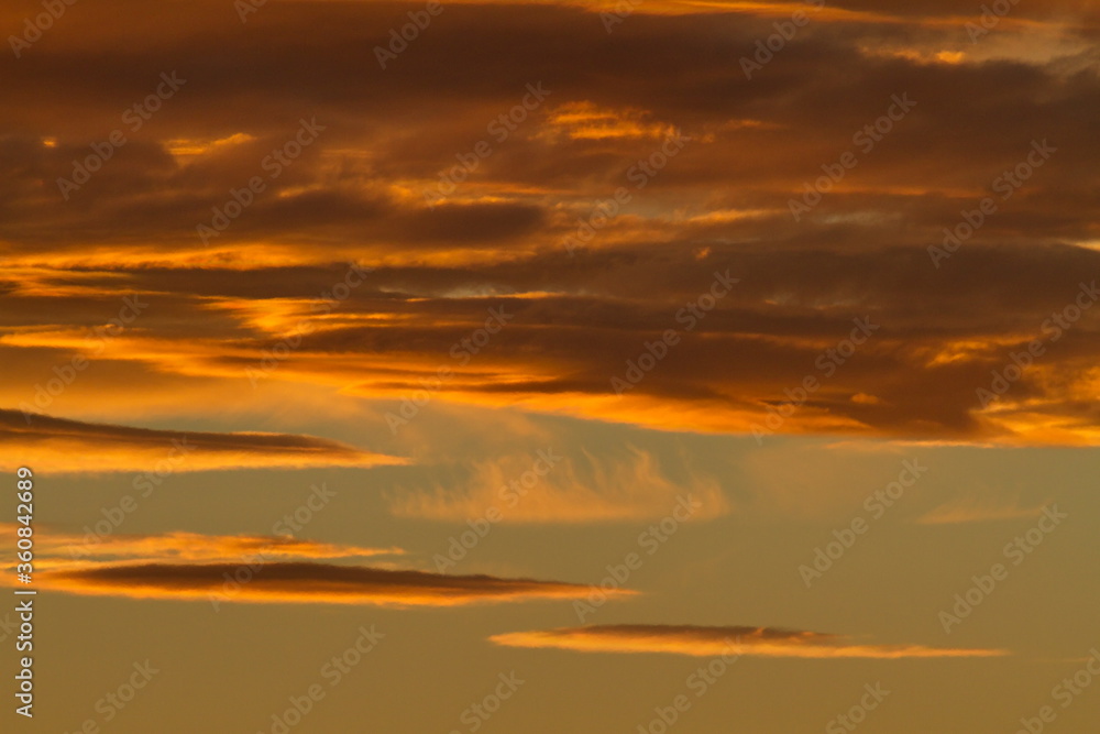Colorful cloud patterns with golden hour light.